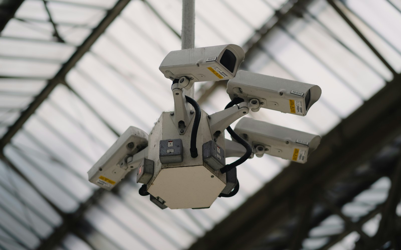 Ceiling-mounted surveillance cameras covering an indoor area