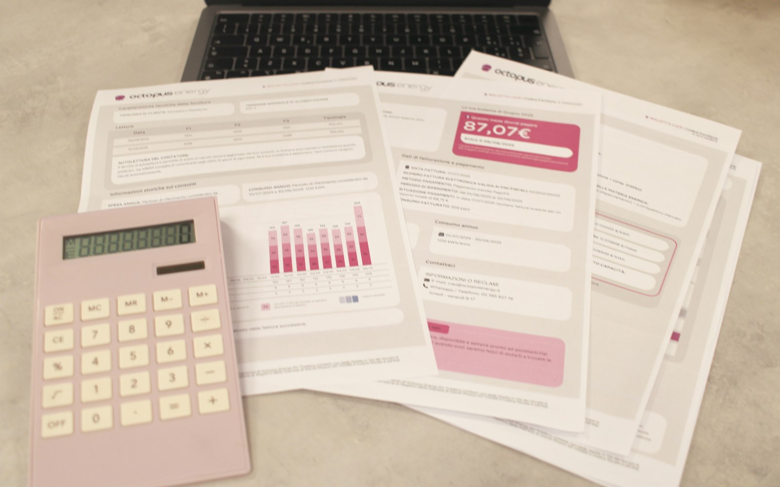 Bills, calculator and laptop on a finance desk