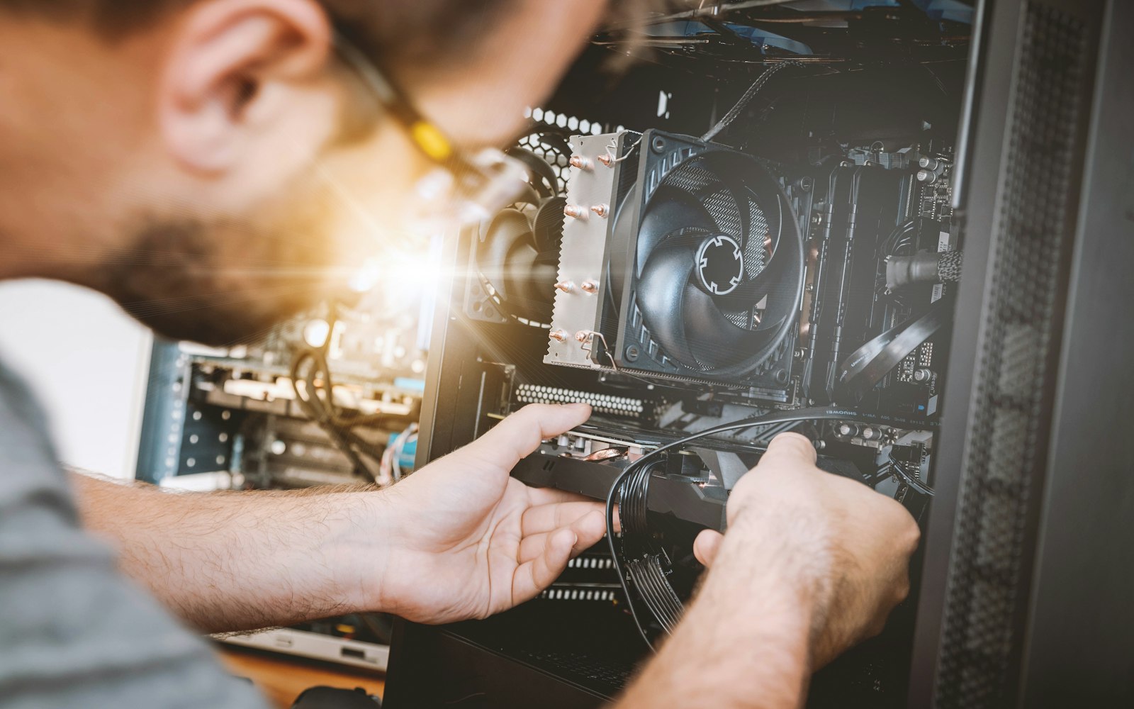 Technician upgrading hardware inside a desktop PC